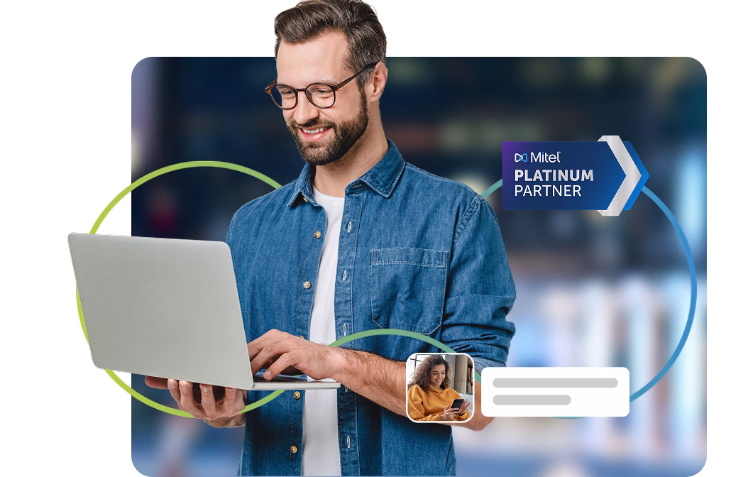 A business professional using a laptop with a Mitel Platinum Partner badge, representing Elite Group's certified Mitel business communication solutions